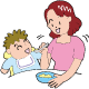 母親が乳児に離乳食を食べさせているイラスト
